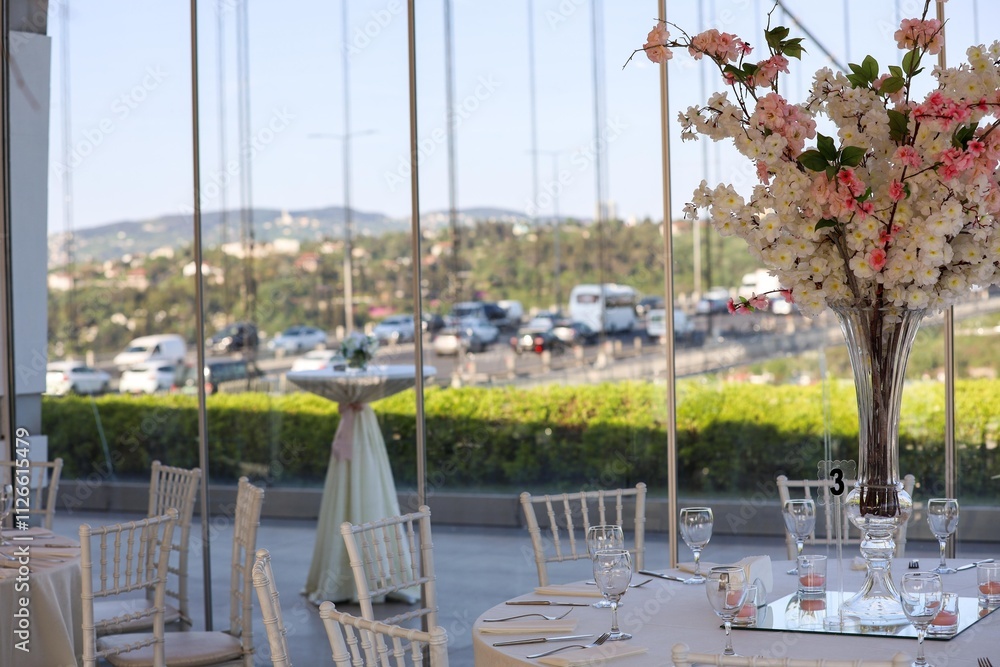 Elegant Outdoor Wedding Reception with Long Tables, White Decor, and Colorful Floral Runner