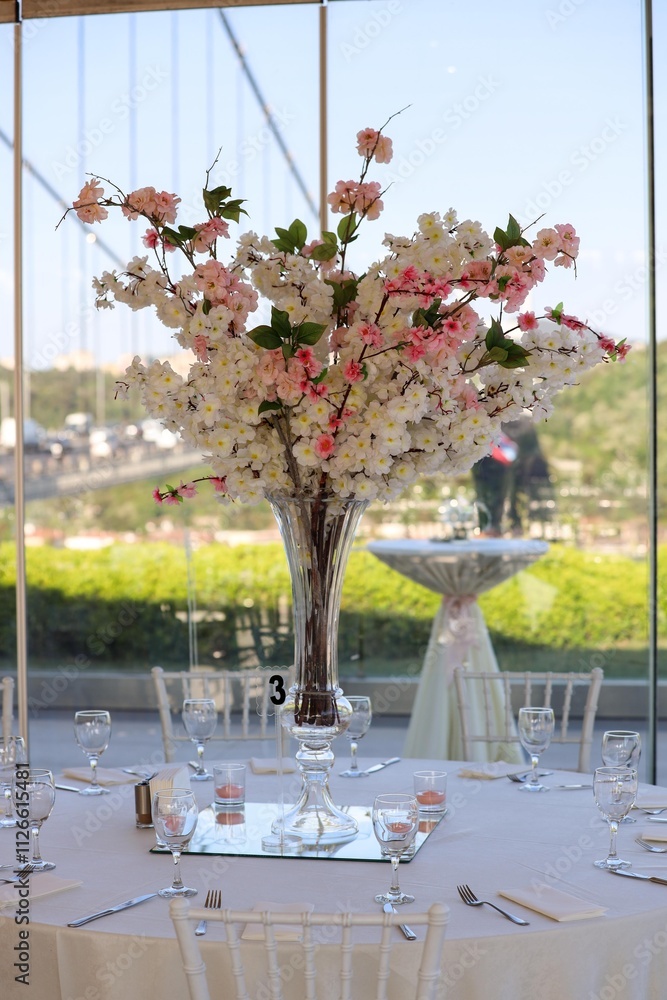 Elegant Outdoor Wedding Reception with Long Tables, White Decor, and Colorful Floral Runner