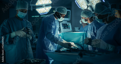 Portrait of a Surgical Team Conducting an Operation in a Dark Hospital Room with Technological Equipment. Black Male Surgeon Having a Discussion with a Nurse while Having an Active Procedure