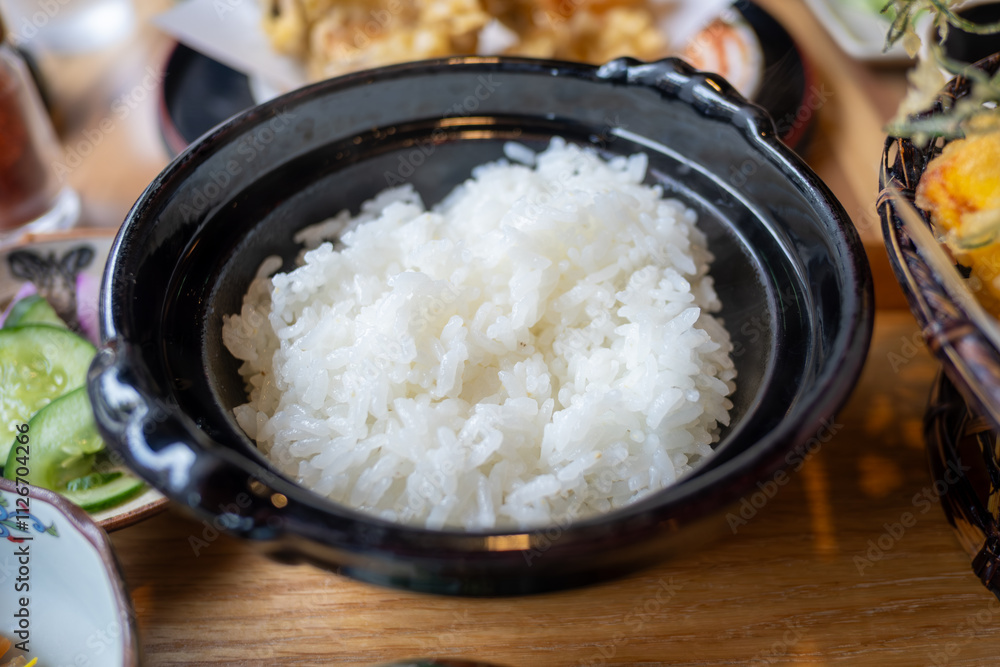 Ginzan onsen, Yamagata, Japan, White rice served in a black bowl on a wooden table. Ginzan onsen, Yamagata, Japan, White rice served in a black bowl on a wooden table.