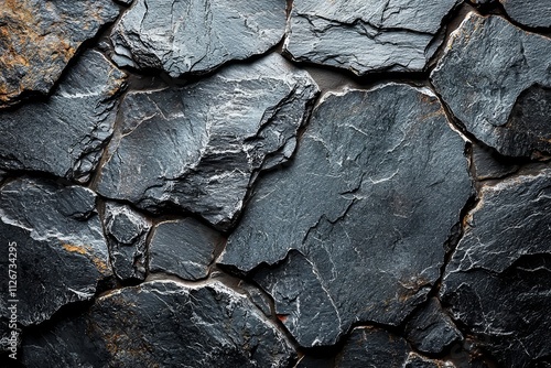 A textured background featuring an abstract pattern of dark gray and black slate stone.