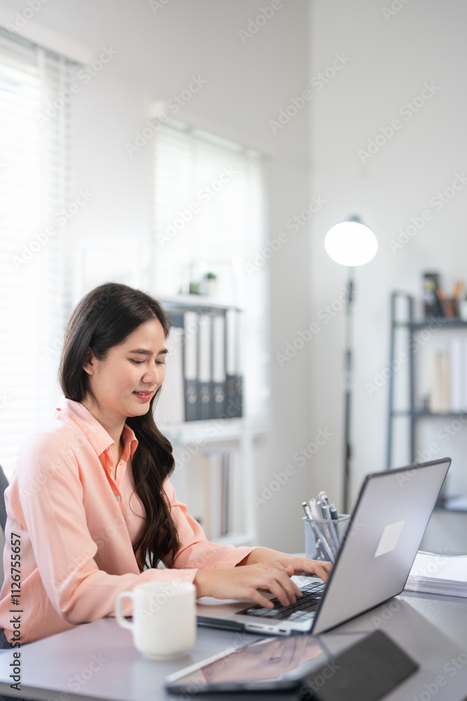 Happy and successful businesswoman inside office at workplace, worker smiling typing and looking at laptop Asian businesswoman is satisfied with results of achievements at work. Happy and successful businesswoman inside office at workplace, worker smiling typing and looking at laptop Asian businesswoman is satisfied with results of achievements at work.
