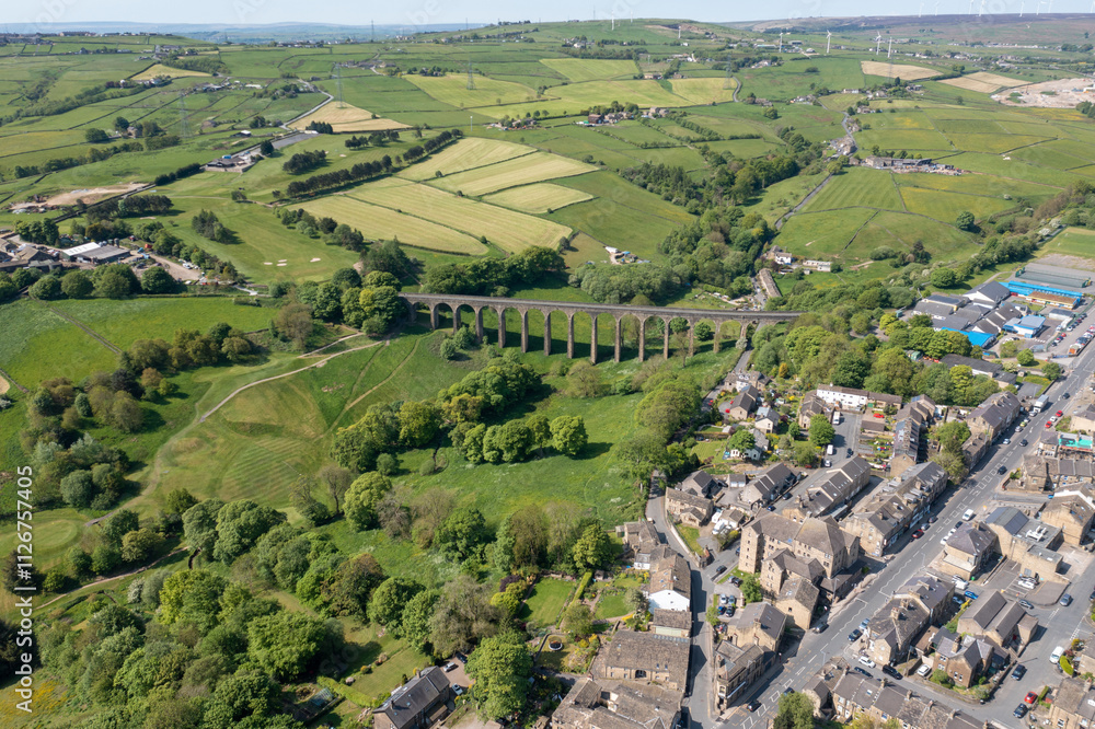 Aerial drone photo of the town of Thornton which is a village within the metropolitan borough City of Bradford in West Yorkshire, England showing the village and famous viaduct in the summer time.