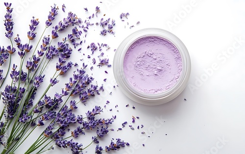 Lavender flowers and a jar of purple powder on a white background. photo