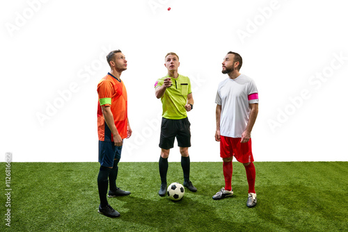 Referee standing between to players from opposite teams and tossing a coin to determine which team will kick off first. Concept of sport, fair play, competition, control, rules photo