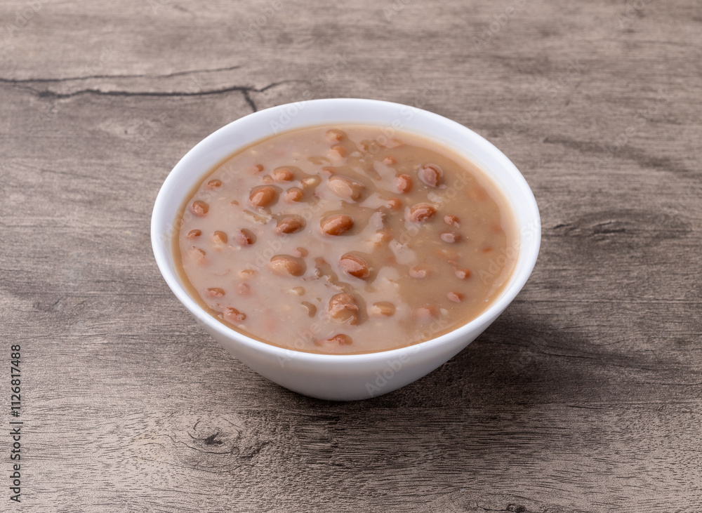 Cooked brown beans in a bowl over wooden table Cooked brown beans in a bowl over wooden table