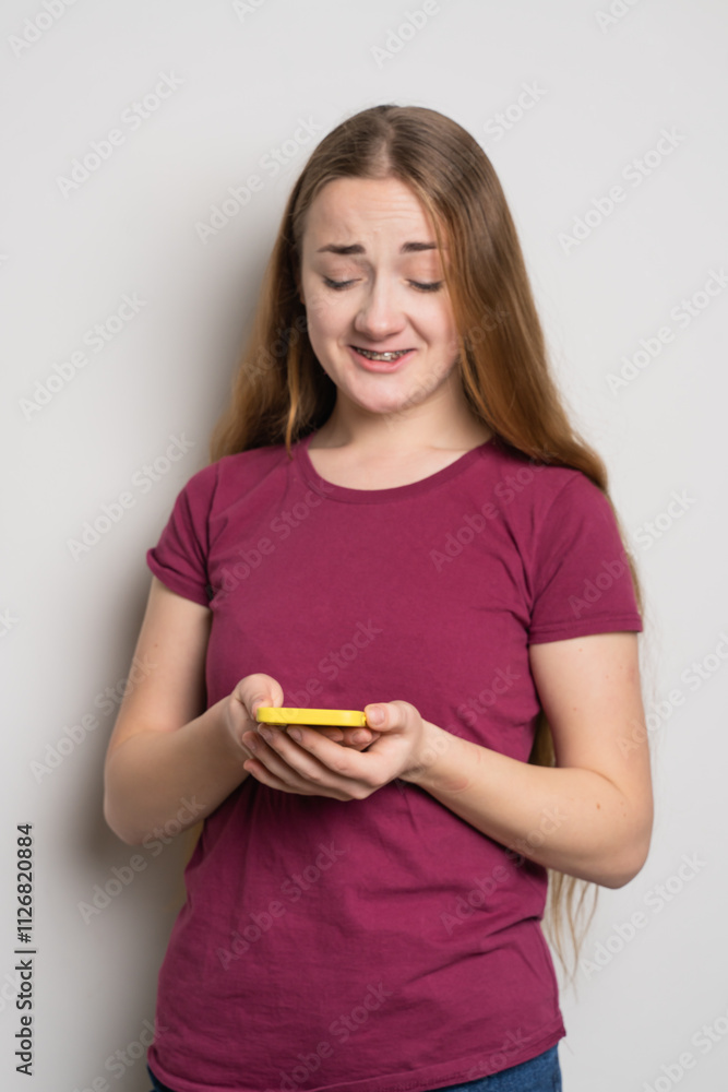 Young beautiful girl uses modern smartphone at home Young beautiful girl uses modern smartphone at home