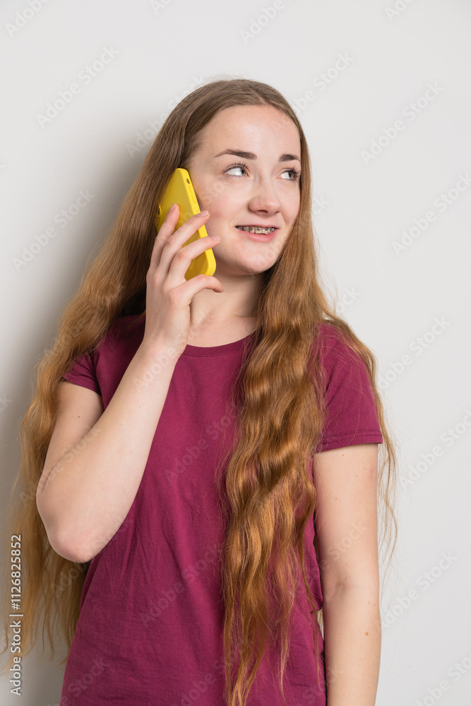 Young beautiful girl uses modern smartphone at home Young beautiful girl uses modern smartphone at home