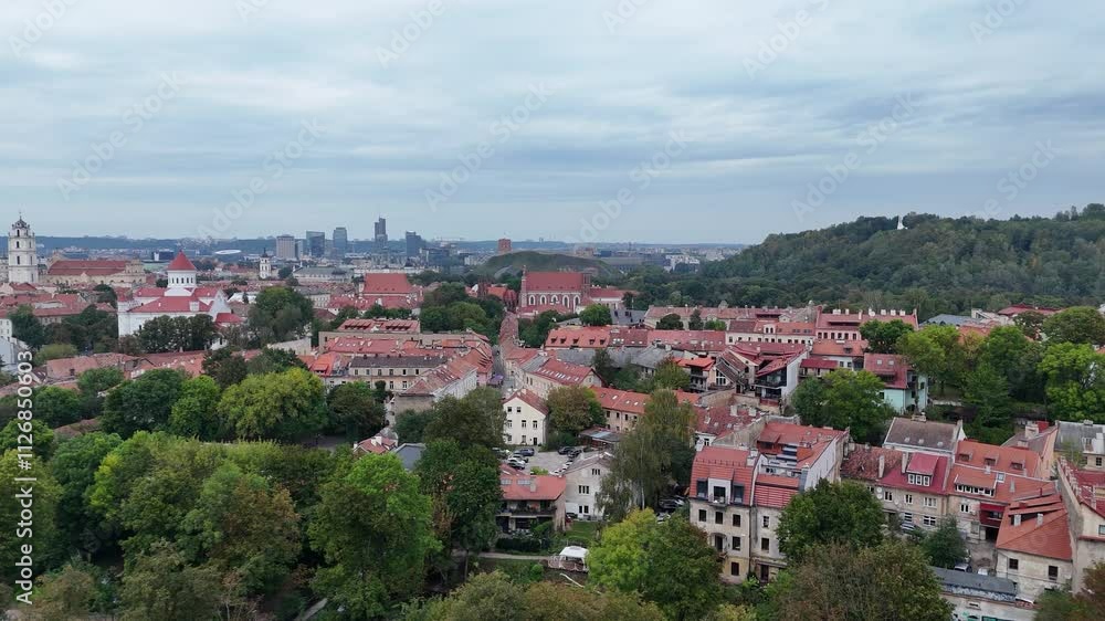 Aerial view of the Vilnius Paupys district showcasing a mix of modern buildings, historic structures, and green surroundings. Aerial view of the Vilnius Paupys district showcasing a mix of modern buildings, historic structures, and green surroundings.
