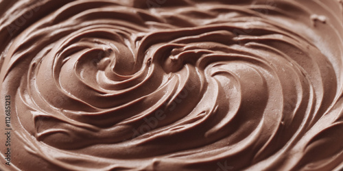 Close up of mocha mousse cream texture with swirl. Chocolate, coffee or cocoa cream or ganache. Banner with copy space for cafe, culinary blog, shop advertising. Trend color of the year - 2025.