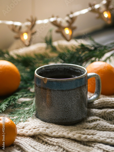 christmas decoration on the table and warm tea in a cup