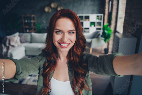 Photo of lovely young ginger girl cheerful smile take selfie photo dressed khaki garment spacious house indoors room photo