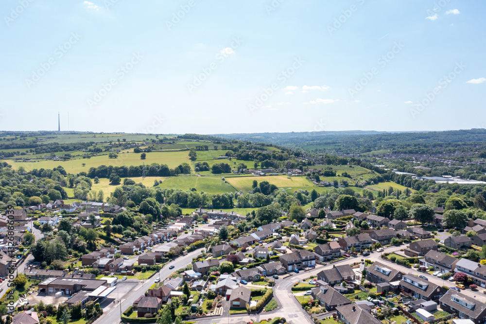Aerial drone photo of the village of Kirkheaton, Huddersfield in the Kirklees district in the county of West Yorkshire England showing the village and River Calder from above in the summer time.