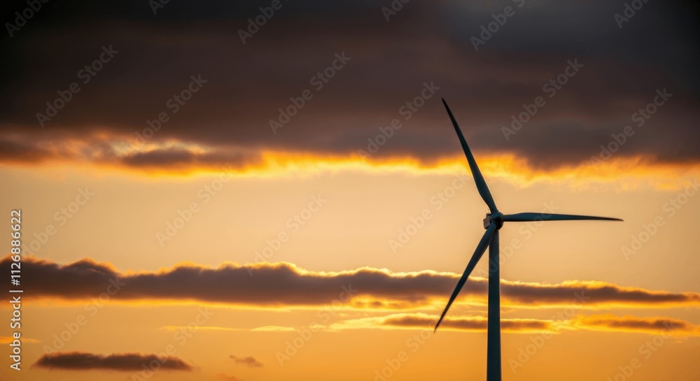 Sunset silhouette of lone wind turbine dramatic sky Sunset silhouette of lone wind turbine dramatic sky