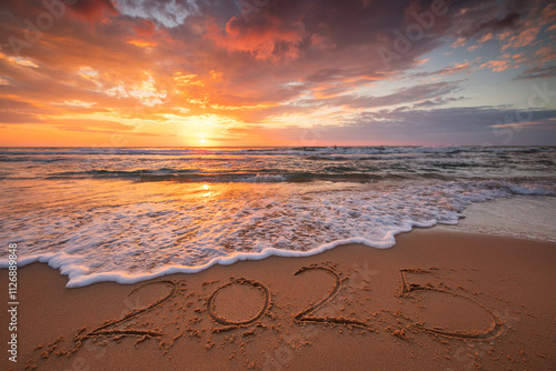 Fototapeta Naklejka Na Ścianę i Meble -  Happy New Year 2025 concept, lettering on the beach. Written text on the sea beach at sunrise.