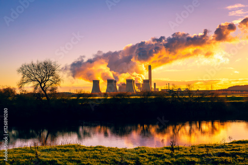 Drax Power in Winter with large plumes of water vapour rising from the cooling towers and reflections in the River Ouse near Hemingbrough, Selby. UK.  Horizontal. Copy space