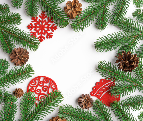 Christmas background. Christmas eve concept. Top view of gift boxes, fir branches, toys, on white background.