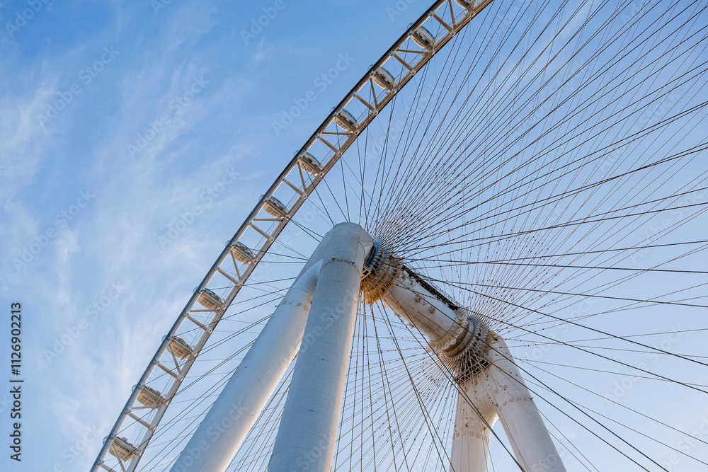 Part of Ferris wheel against the backdrop of a blue sky and the Persian Gulf. Dubai Part of Ferris wheel against the backdrop of a blue sky and the Persian Gulf. Dubai
