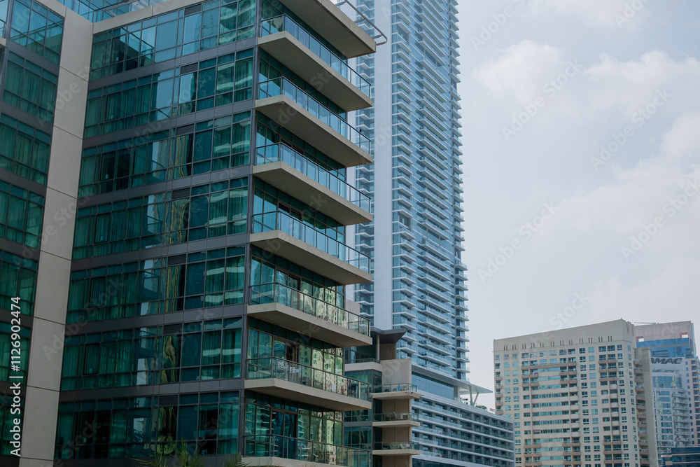 High-rise buildings with glass facade against blue sky. Business center. View from below High-rise buildings with glass facade against blue sky. Business center. View from below