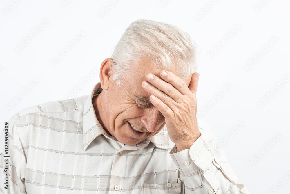 Mature man clutching his head with his hands. Older man suffers from headache, forgetfulness, memory problems. Mature man clutching his head with his hands. Older man suffers from headache, forgetfulness, memory problems.