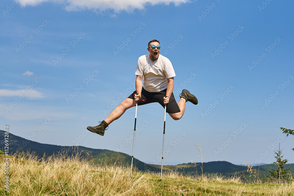 Happy Man Jumping with Trekking Poles in Scenic Mountain Landscape, Radiating Joy, Energy, and Love for Adventure and Summer Hiking Outdoors Happy Man Jumping with Trekking Poles in Scenic Mountain Landscape, Radiating Joy, Energy, and Love for Adventure and Summer Hiking Outdoors