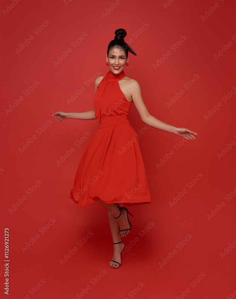 fashionable young Asian elegant woman in red dress posing isolated on red background fashionable young Asian elegant woman in red dress posing isolated on red background