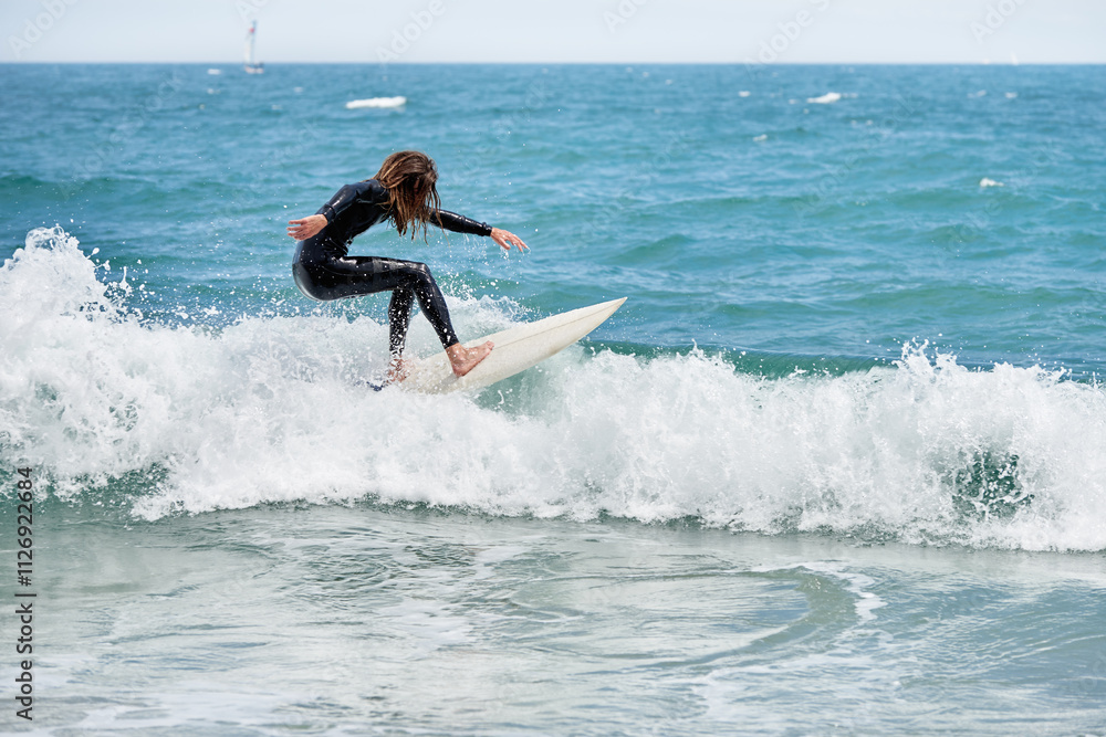 Long-haired bearded surfer on board riding waves Long-haired bearded surfer on board riding waves