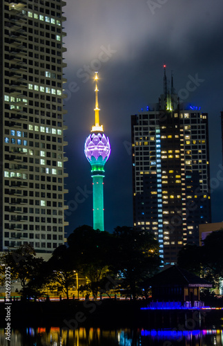Colombo Lotus tower with lights in the city at night through the buildings 
