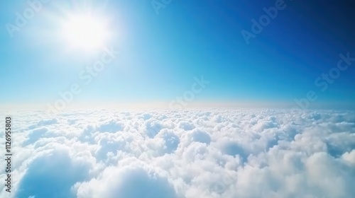 Bright Sunlight Shining Over Soft White Clouds in Clear Blue Sky