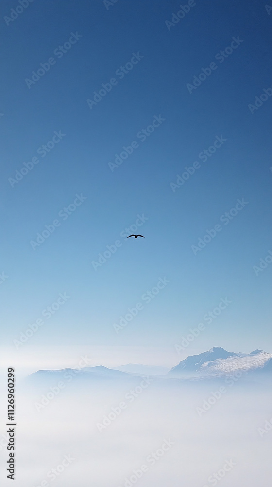 A single bird soars gracefully against a clear blue sky, surrounded by distant mountain peaks and a soft mist, evoking a sense of freedom and tranquility A single bird soars gracefully against a clear blue sky, surrounded by distant mountain peaks and a soft mist, evoking a sense of freedom and tranquility