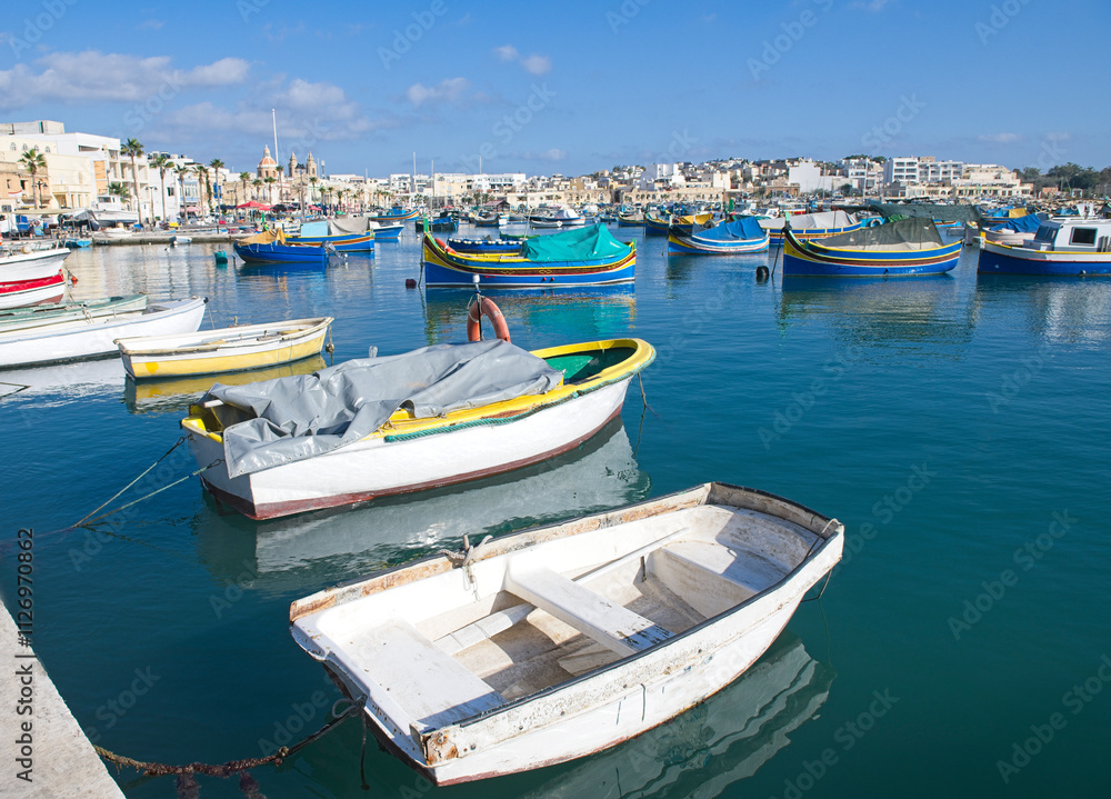 Boats moored in the harbour in winter, Marsaxlokk, Malta Boats moored in the harbour in winter, Marsaxlokk, Malta