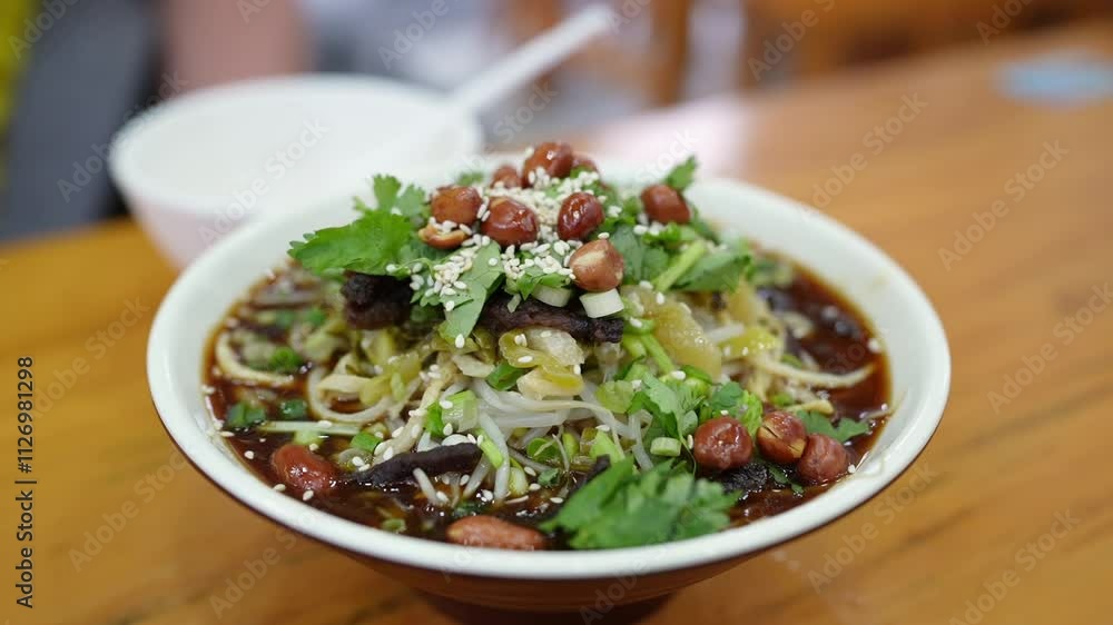 Enjoy a Delicious Bowl of Spicy Noodle Salad, Complete with a Variety of Toppings Enjoy a Delicious Bowl of Spicy Noodle Salad, Complete with a Variety of Toppings