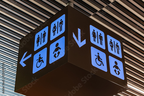 Restroom sign blue lit and black. wc for wheelchairs, Male, Female, baby care photo