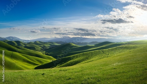 beautiful panoramic landscape of rolling green hills under a bright sky