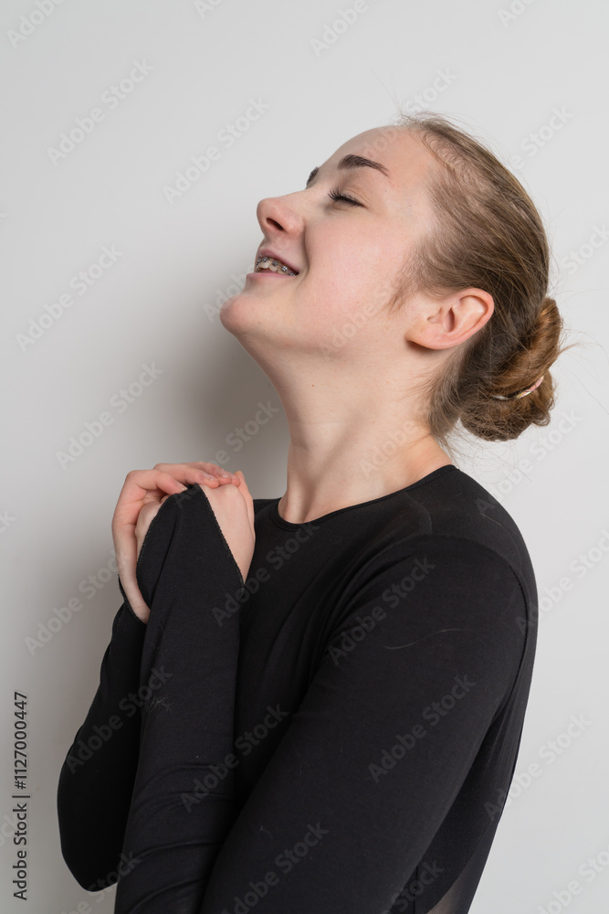 Woman dancer in black wear smiling with braces on her teeth Woman dancer in black wear smiling with braces on her teeth