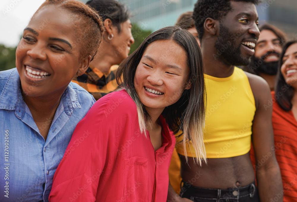 Obraz premium Crowd of multiracial people having fun hugging each other in the city - Diverse young friends and party concept - Focus on asian woman face