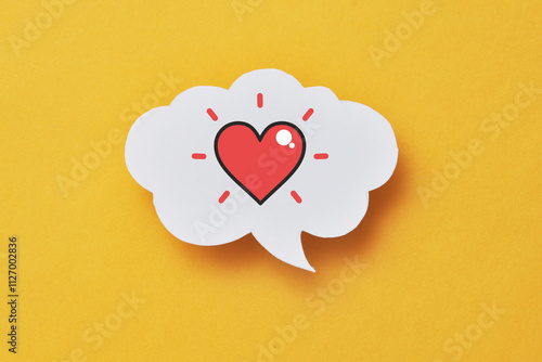 A red paper heart on a speech balloon. A symbol of love, conversation and declaration of love photo