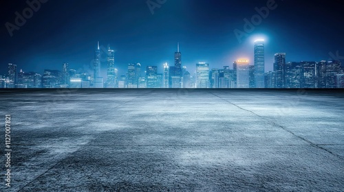 A panoramic view of a city skyline at night with a focus on an empty foreground.