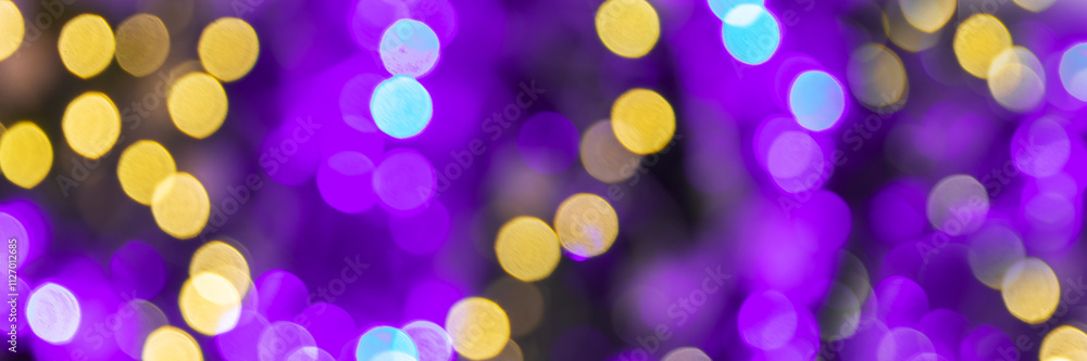Purple and gold bokeh holidays lights at night, christmas, new year or Mardi Gras carnival party panoramic web banner background
