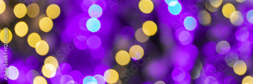 Obraz na płótnie Purple and gold bokeh holidays lights at night, christmas, new year or Mardi Gras carnival party panoramic web banner background w salonie