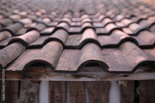 Rooftiles that have been eaten away by age. pattern rooftile,rows of rooftiles lined up