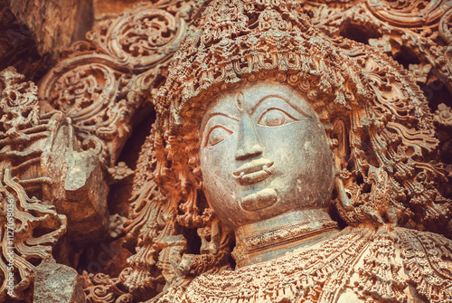 Face of Shiva Lord sculpture on wall of old relief. Ancient temple in India