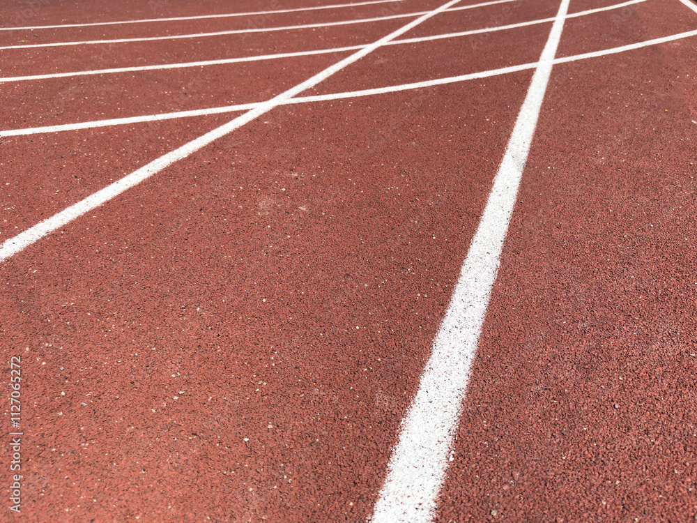 Red treadmill with the lines at the stadium. Treadmill lane on sport field. Running track on the stadium. Red treadmill in sport field. Running track Red treadmill with the lines at the stadium. Treadmill lane on sport field. Running track on the stadium. Red treadmill in sport field. Running track