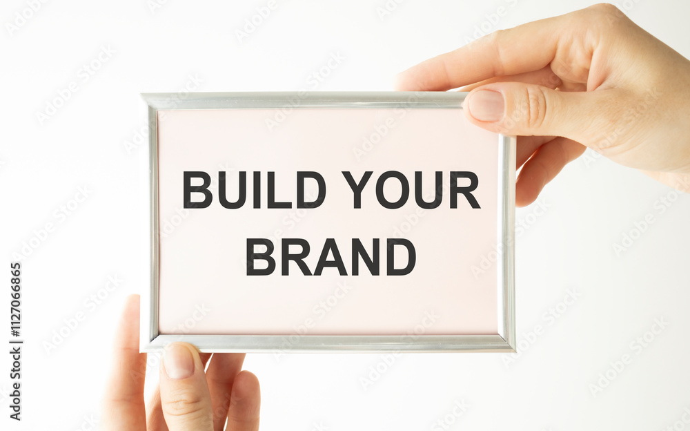 note paper written build your brand over white background note paper written build your brand over white background