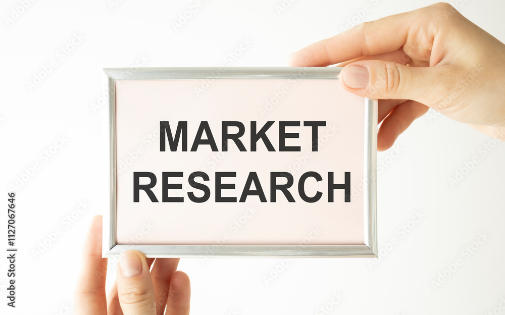 Woman hands holding cardboard card with words Market Research. Woman hands holding cardboard card with words Market Research.