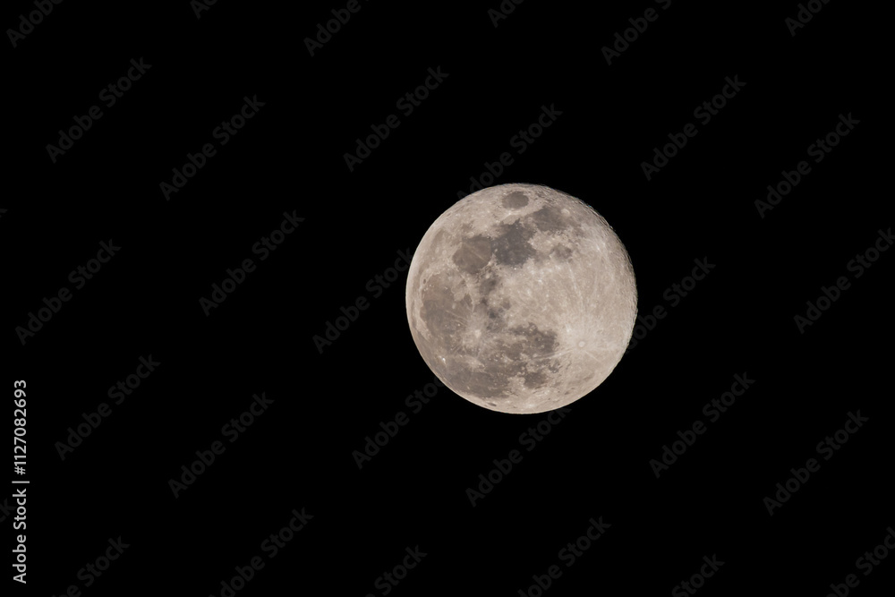Close up of full moon on the dark night seen with the lens super Close up of full moon on the dark night seen with the lens super