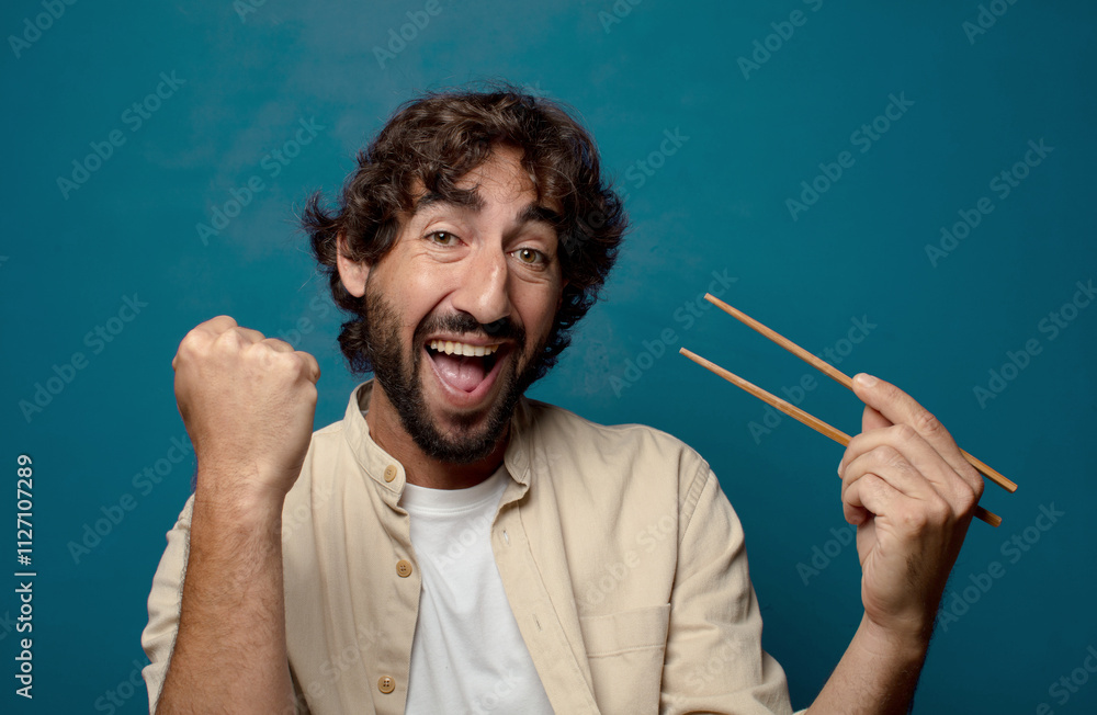 young adult bearded man with chopsticks young adult bearded man with chopsticks