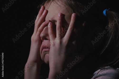 Close up portrait of stressed, unhappy young adolescent girl crying and feeling exhausted or depressed alone. Horizontal image.