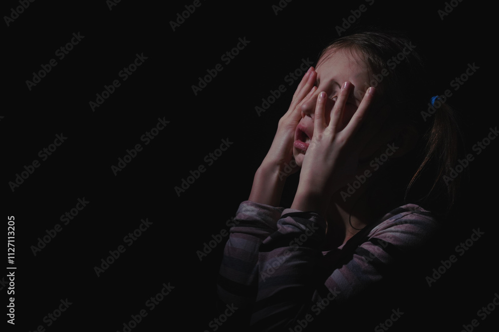 Close up unhappy young adolescent girl crying and feeling exhausted or depressed alone. Copy space for text or design. Close up unhappy young adolescent girl crying and feeling exhausted or depressed alone. Copy space for text or design.