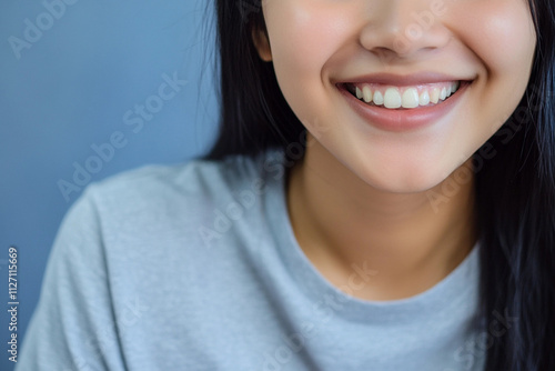 Smiling young woman in casual attire with natural background